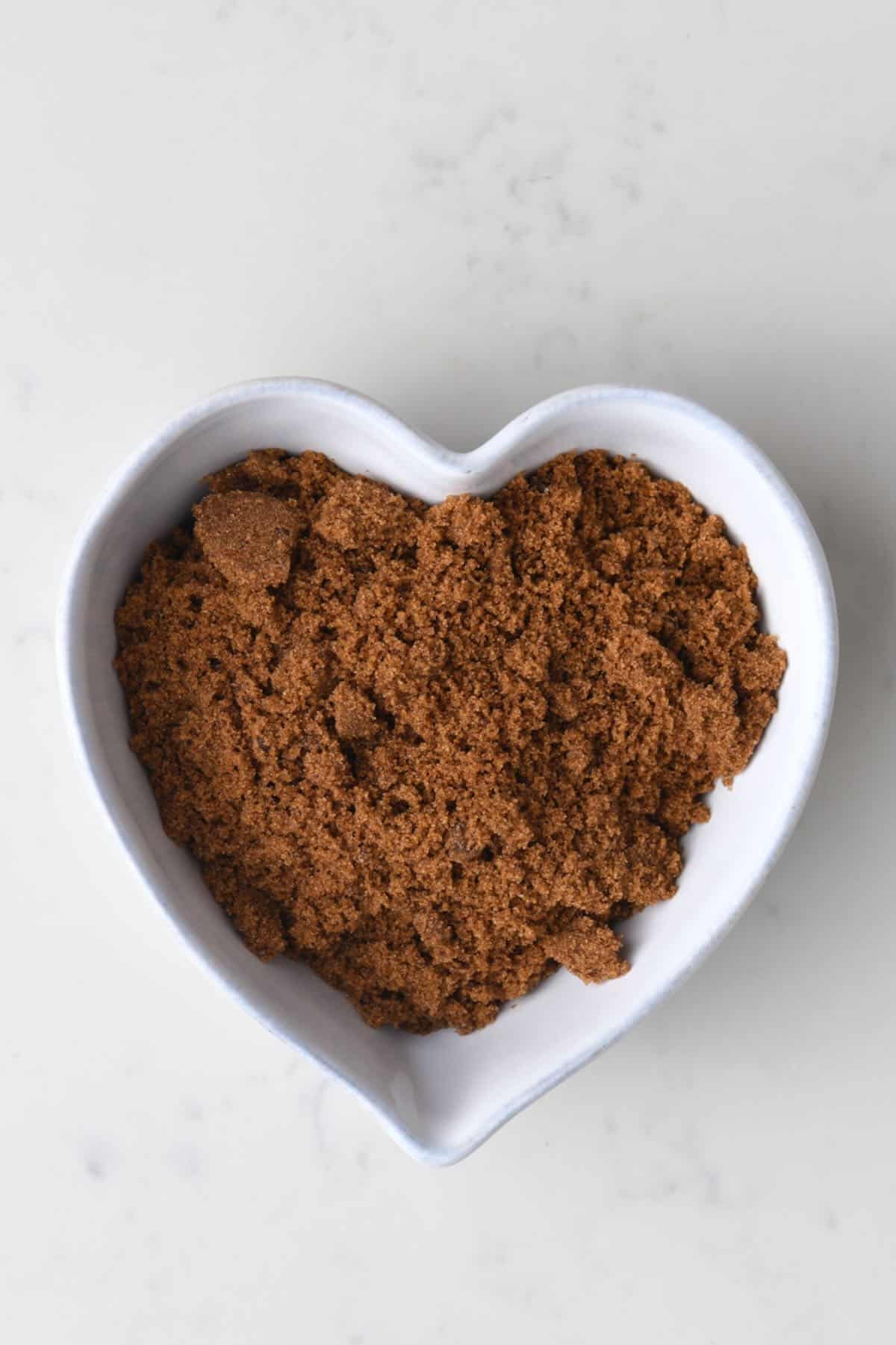 Dark brown cane sugar in a white ceramic bowl